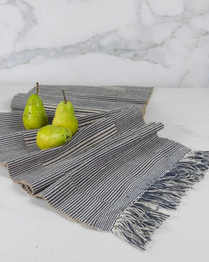 Table runner handloomed textile with pears on a marble surface