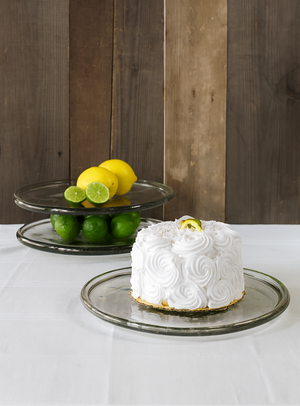 White cake on TerraKlay's glass plate with lemons and limes.