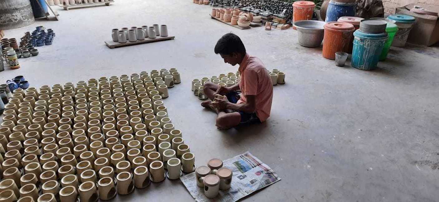 TerraKlay artisan at work making fair trade mugs and cups for your tea or coffee.