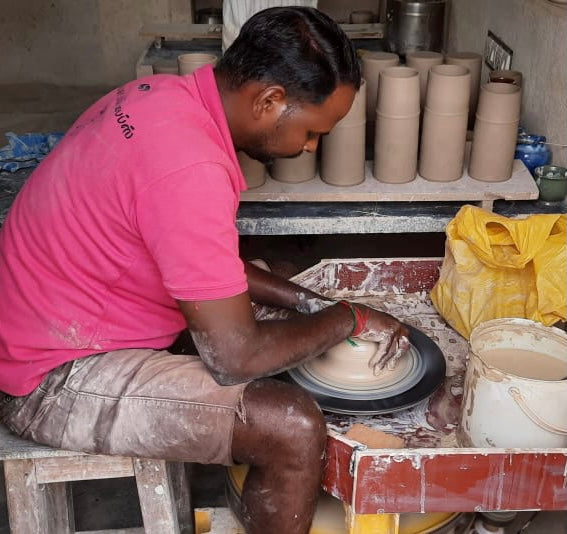 TerraKlay pottery artisan at work making stoneware mugs and cups for your everyday use.