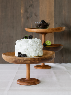 White frosted cake on a Large wooden stand by TerraKlay with blackberries