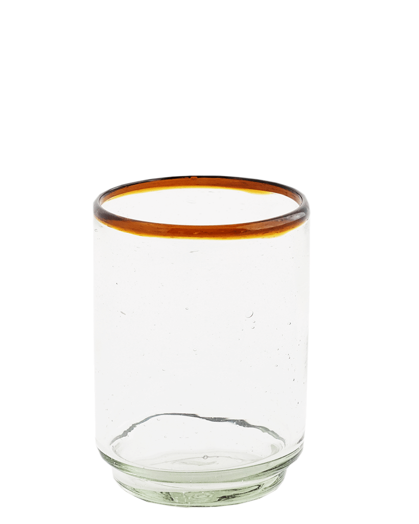 A clear glass with an amber-colored rim, handcrafted with a stacking design, made from recycled materials.