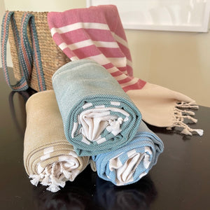 Terraklay bath towel in four colors of red, blue, tan, and green all hand woven using organic cotton.