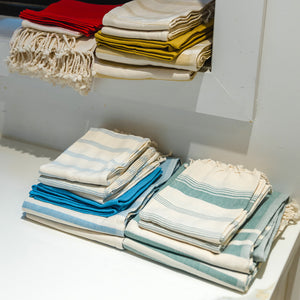 set of towels on closet- green,blue,beige